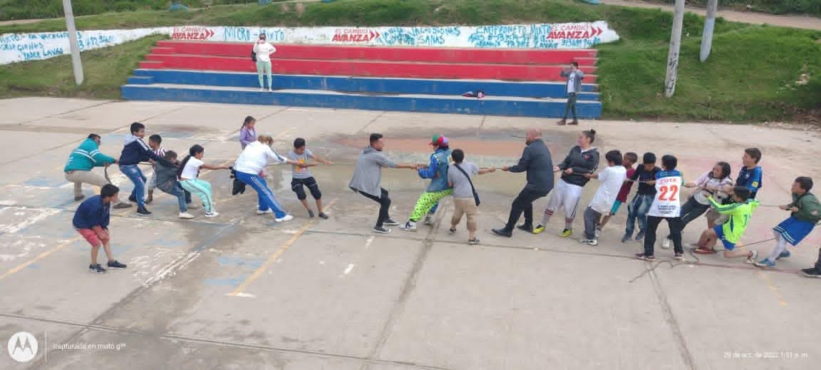 Actividad recreativa de tira y afloja con la comunidad y los niñes